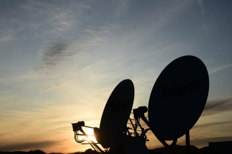 Two satellite dishes At sunset, silhouette