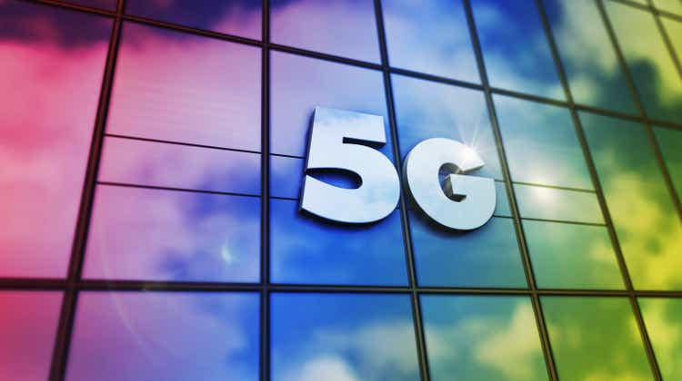 5G mobile communication symbol on glass wall and mirrored building