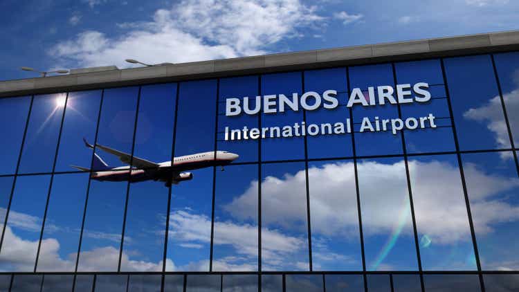 Airplane landing at Buenos Aires mirrored in terminal