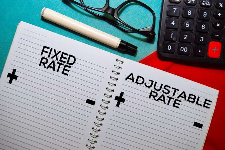 Fixed Rate and Adjustable Rate text on a book isolated on office desk.