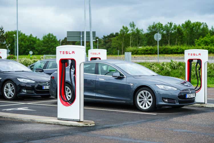 Parked Tesla on charge point for fulling battery on charging station