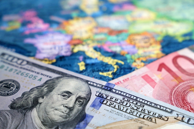 US dollar and Euro banknotes on the map of Europe