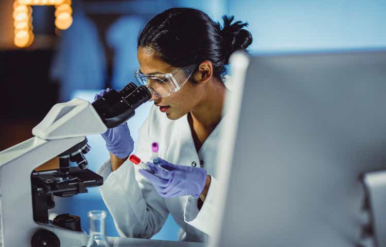 Young Scientist Looking Through a Microscope