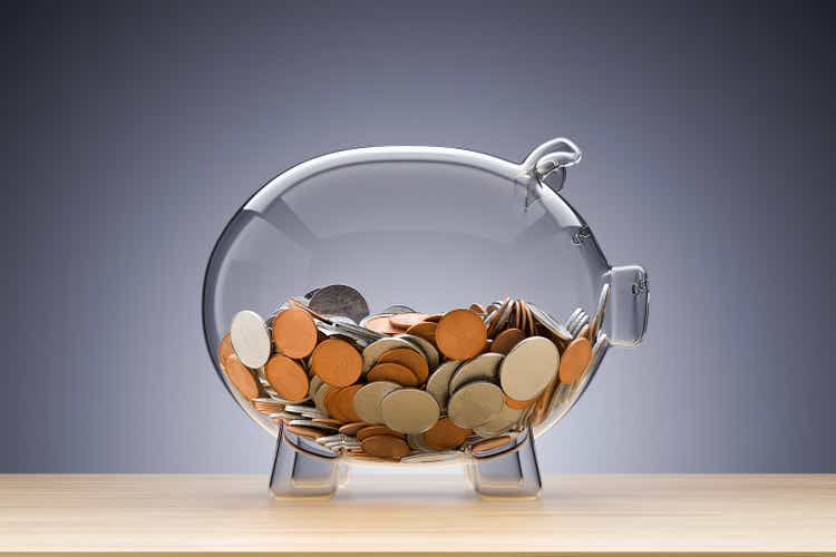 Glass piggy bank with coins