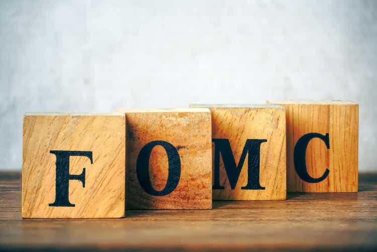 Text "FOMC" on wood table,USA economic data concept.