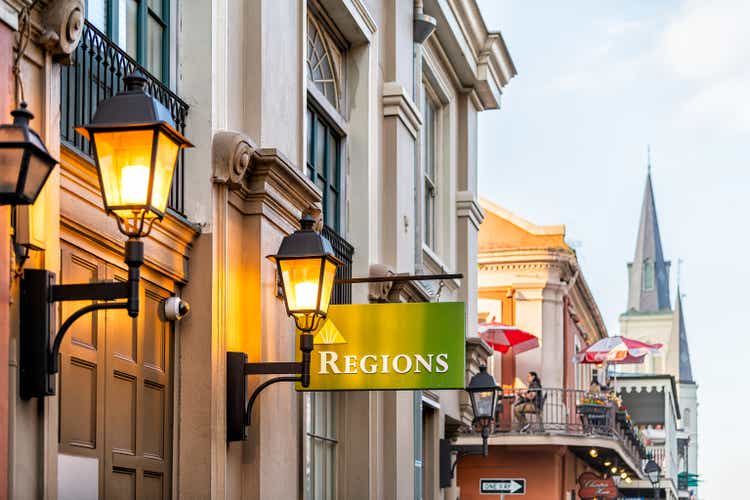 Chartres street in New Orleans with St Louis Cathedral and sign for regions bank