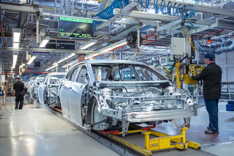 Workers on car production line in car factory
