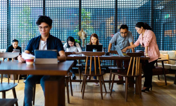 Asians working in busy coworking space