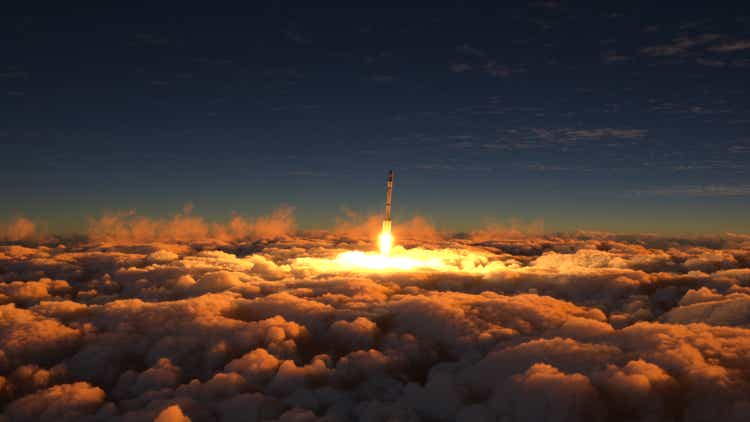 The rocket flies in the clouds at sunset