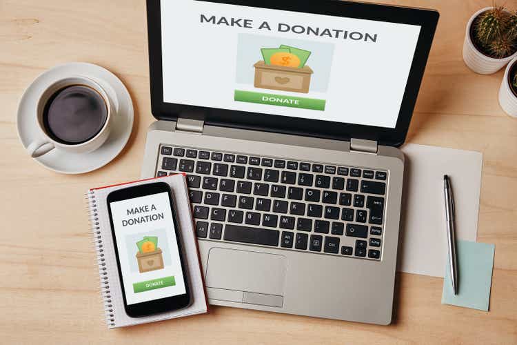 Donation concept on laptop and smartphone screen