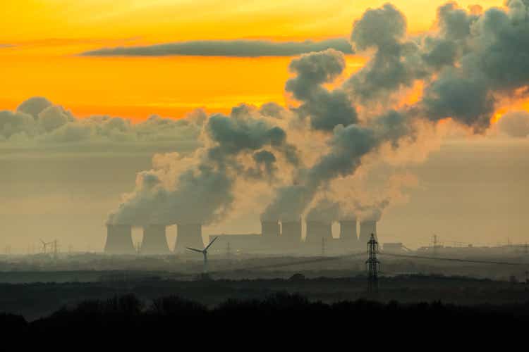 The imposing cooling towers of a Power Station near Drax in North Yorkshire, UK, with plumes of water vapour hitting the cold night air in Winter.