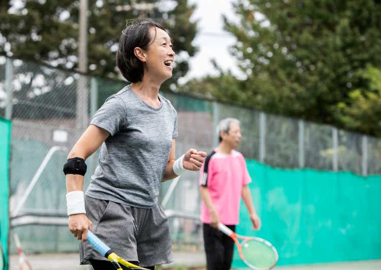 Japanese women enjoying tennis with friends