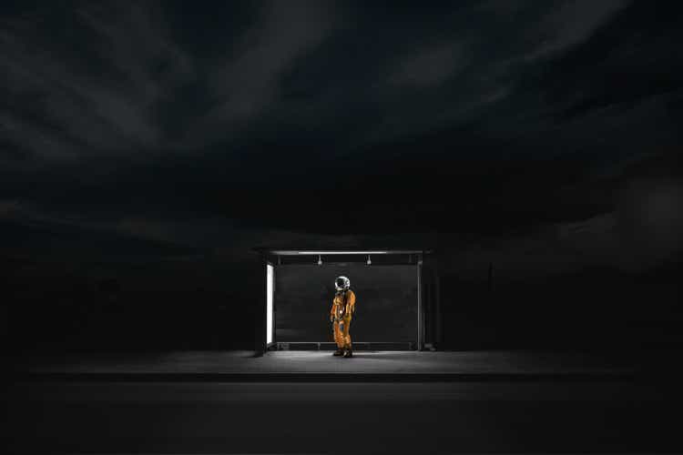 Astronaut waiting at a bus stop