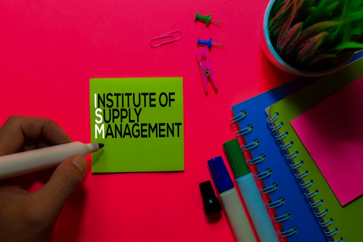 ISM. Institute of Supply Management acronym on sticky notes. Office desk background