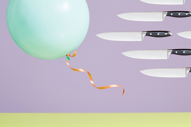 A group of kitchen knives chasing a balloon