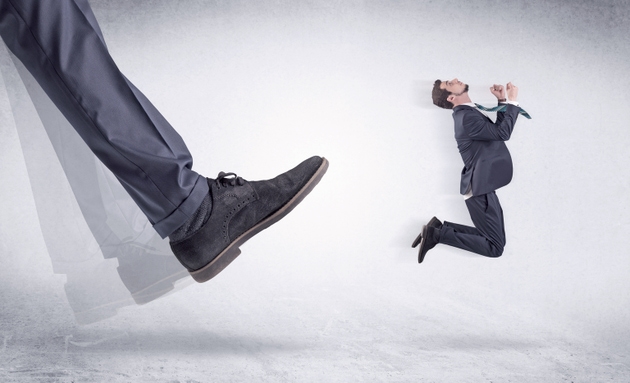 Black shoe kicking small man