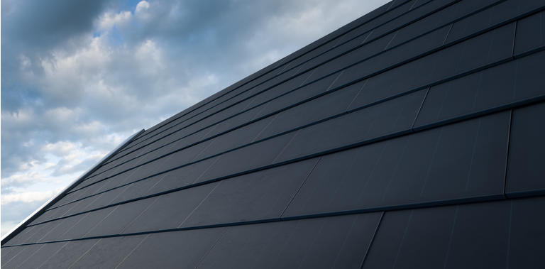 Black solar roof concept. Building-integrated photovoltaics system consisting of modern monocrystal black solar roof tiles. 3d rendering.