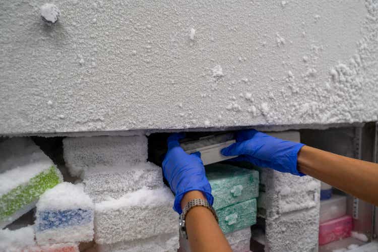 The researcher opens the storage box that keeps the sample in -80C refrigerator. To finds samples of protein used for the further experiment for biochemical laboratory.