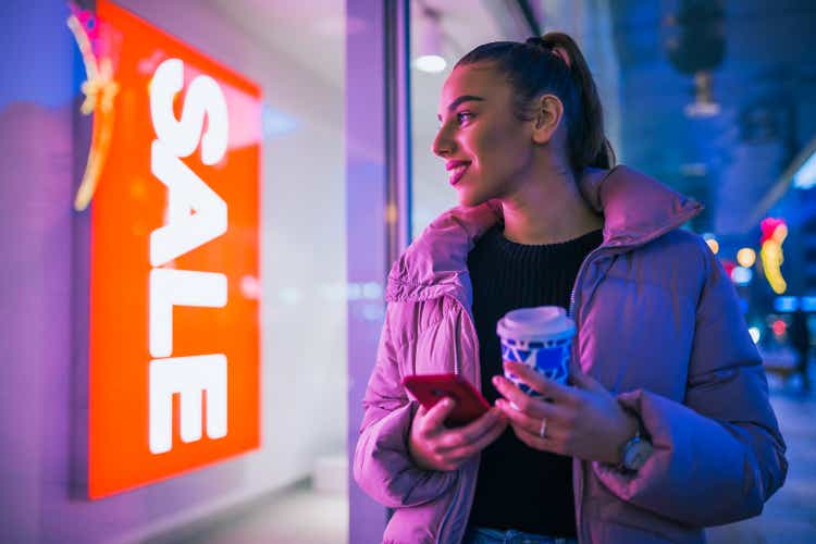 Woman standing on front of shop window