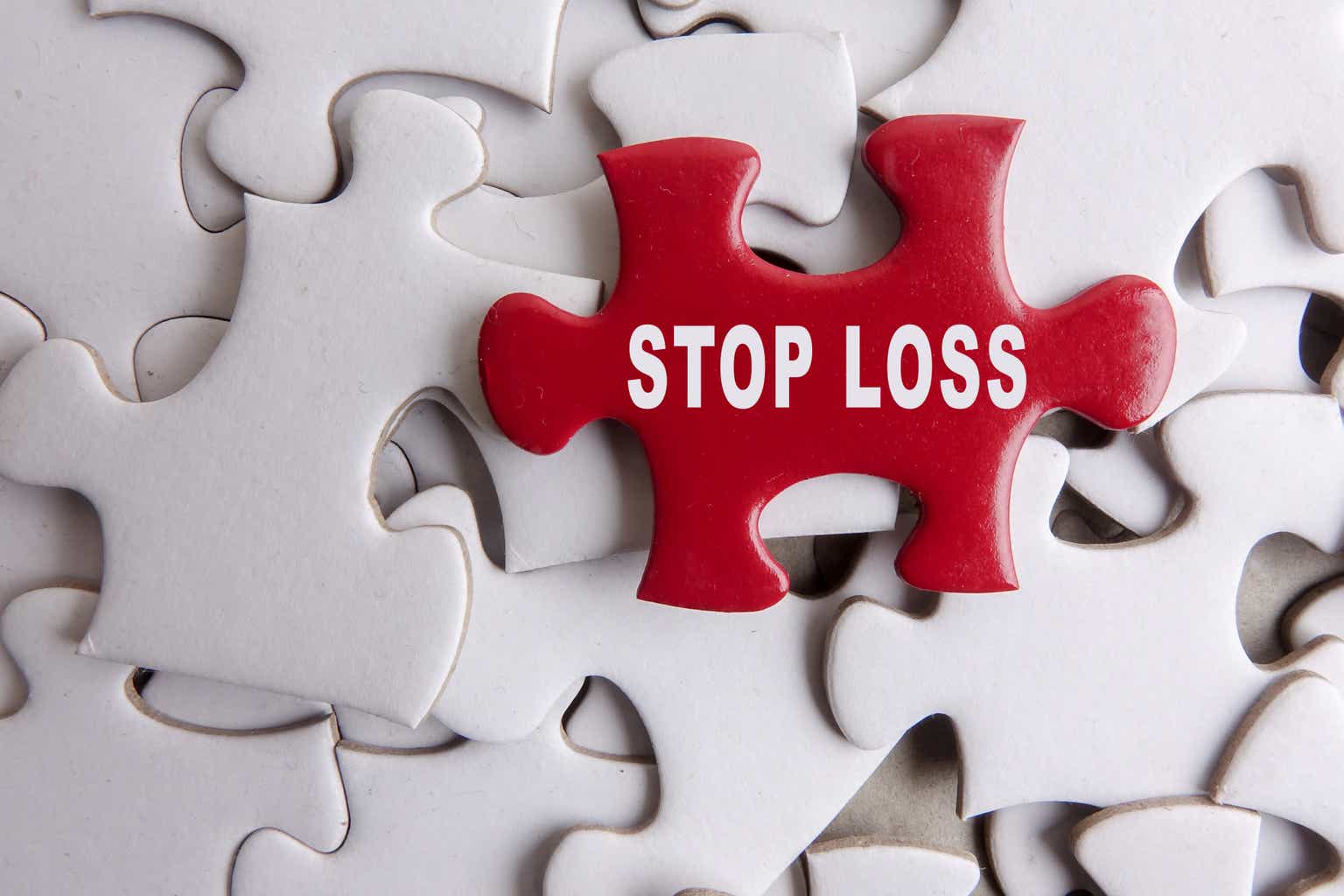 Red puzzle on a white puzzle background with text STOP LOSS. FOREIGN EXCHANGE CONCEPT