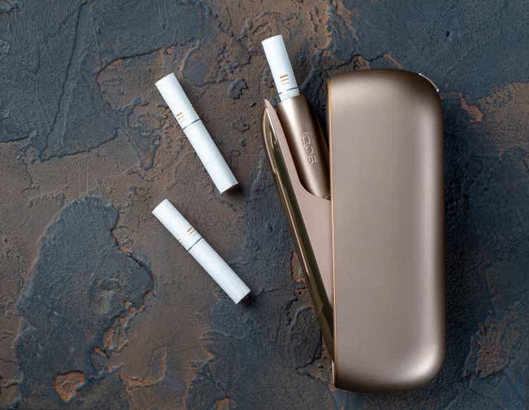 January 15, 2020, Monchegorsk, Russia. Gold IQOS electronic cigarette on a dark background, Marlboro and Philippe Morris iqos, which is described as a hybrid cigarette between analog and electronic
