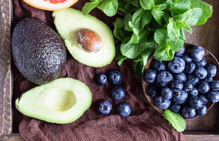 Purple smoothie with blueberries, mint, avocado and grapefruit in wooden tray. Healthy food. Summer breakfast or lunch.