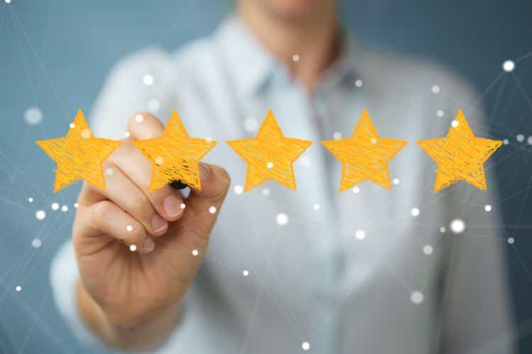 Businesswoman on blurred background rating with hand drawn stars