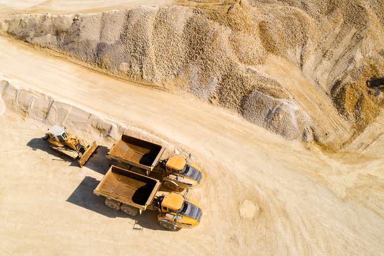 Dump Trucks and Bulldozer in a Quarry, Aerial View