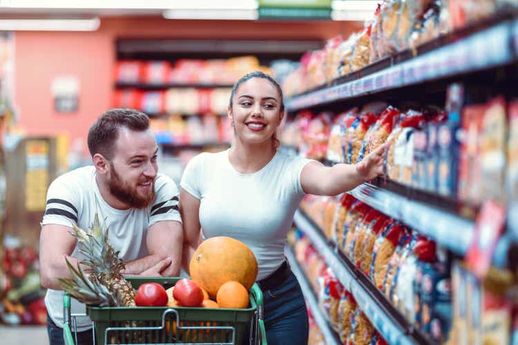 Male And Female Buying Some Pasta In Supermarket