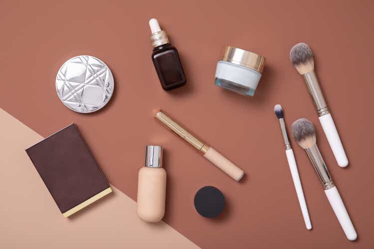 Professional make-up artist flat lay on beige background for fashion woman.