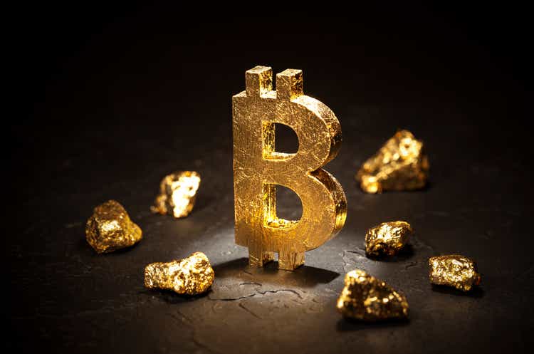 Gold sign bitcoin and gold nuggets on black background