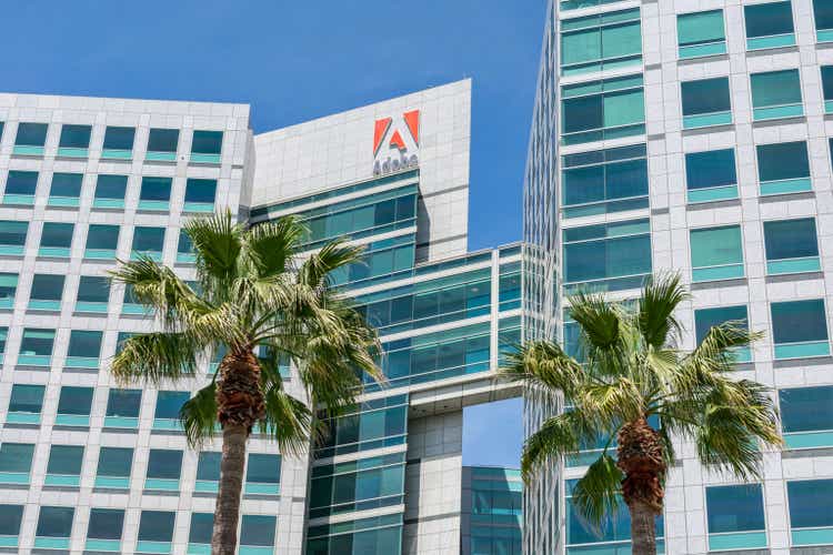 Adobe logo is displayed on Adobe Inc. office headquarters towers. Logo features the alphabet "A" portrayed in white on a red background