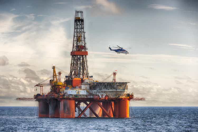 Chopper landing on a oil rig at day