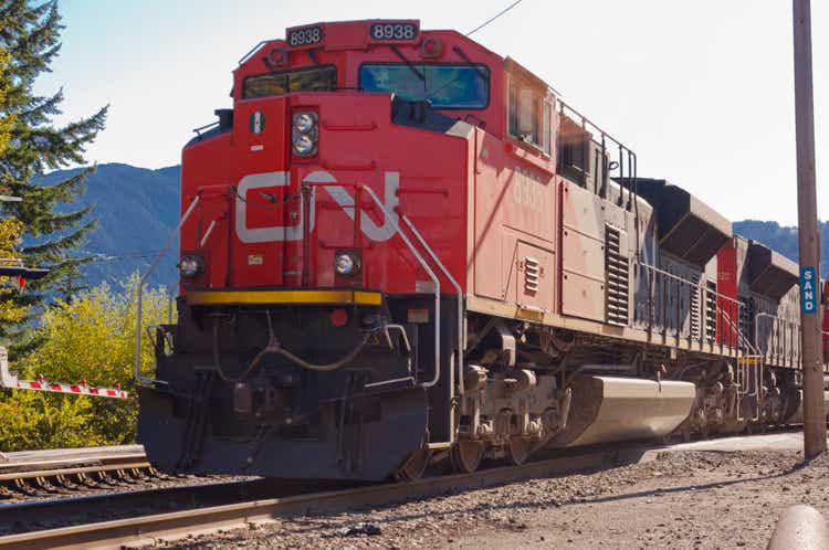 A locomotive is traveling across a railway crossing