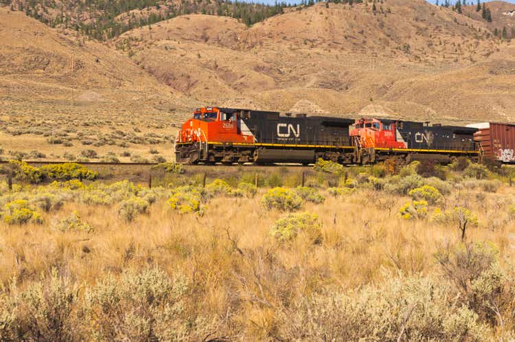 Canadian National train rolling across grassy hills