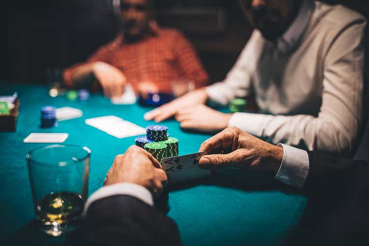 Man holding two aces in poker game