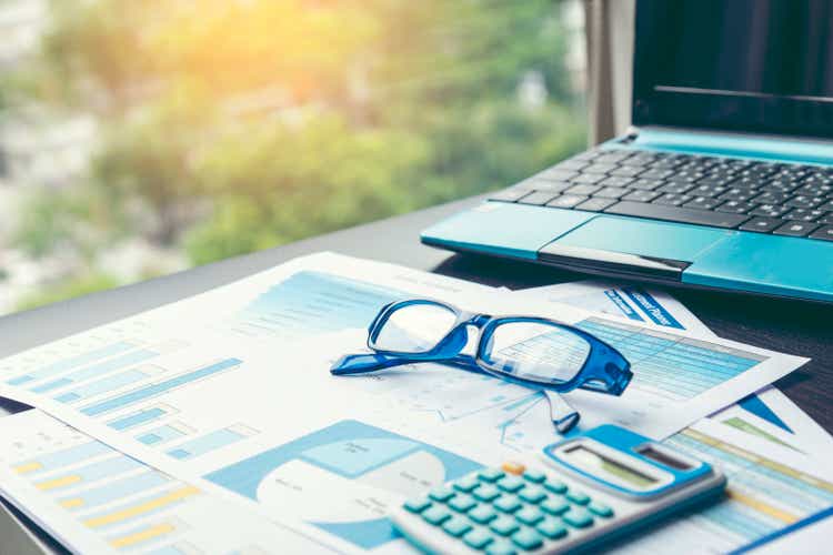 Excel graph with Spreadsheet Document showing Information Financial Startup Concept. Financial Planning making Accounting Database Report. Graphs and chart on screen with stationery set business stuff