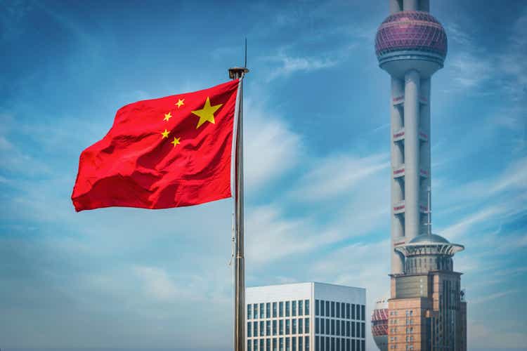 Shanghai Chinese flag in front of the Oriental Pearl Tower