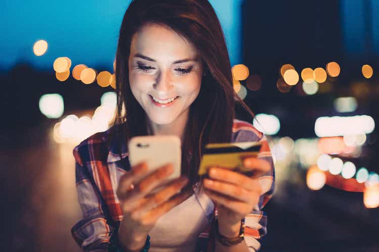 Woman using electronic banking on phone