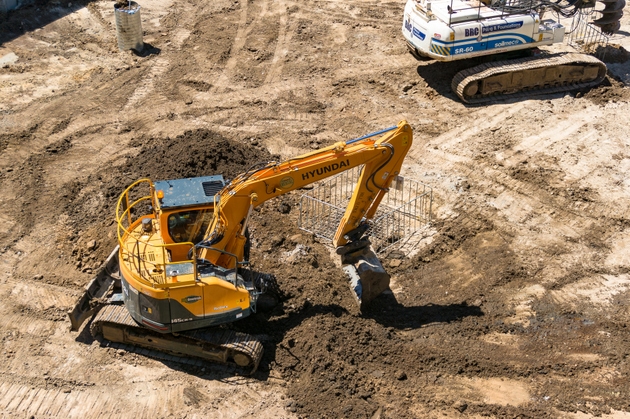 Yellow earth mover, bulldozer on construction site