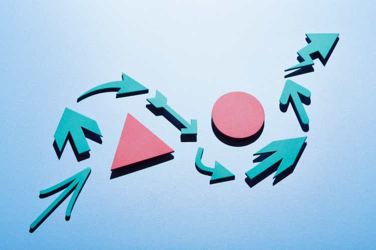 A group of arrows moving up and around obstacles