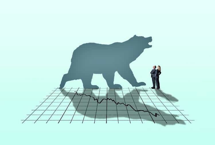 Businessman And Businesswoman Looking Up At Bear Market