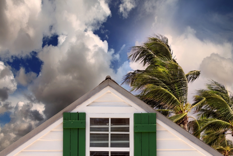 close up rooftop of a wooden house in tropical storm