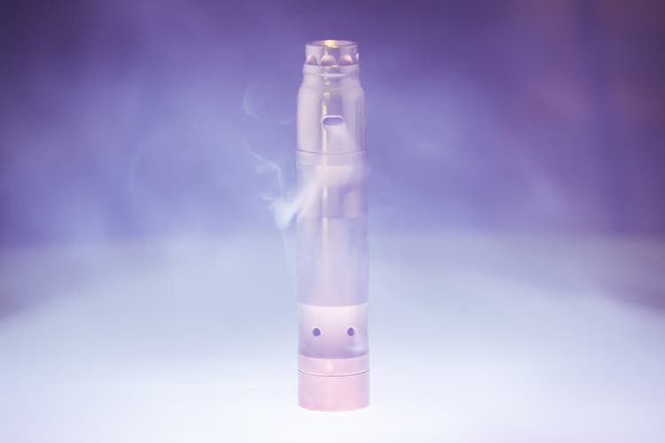 Electronic cigarette with steam in smoke on a dark background