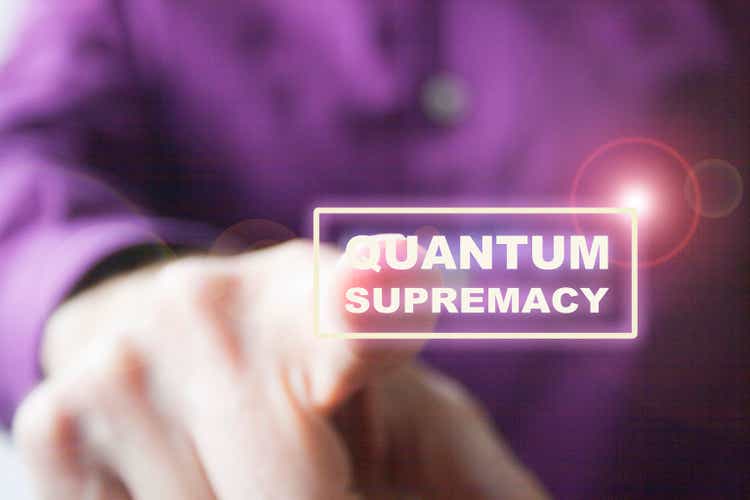 Pressing a virtual quantum supremacy button a right hand of a Caucasian man in purple shirt