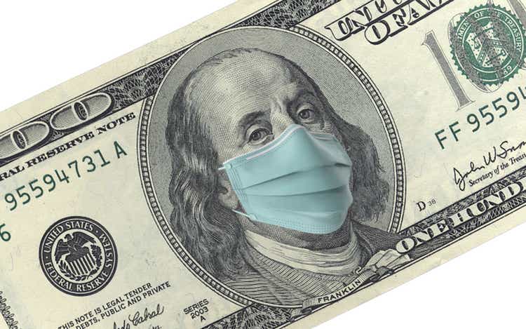 American One Hundred Dollar Bill with Mask Protection For Coronavirus on Economy Against White Background