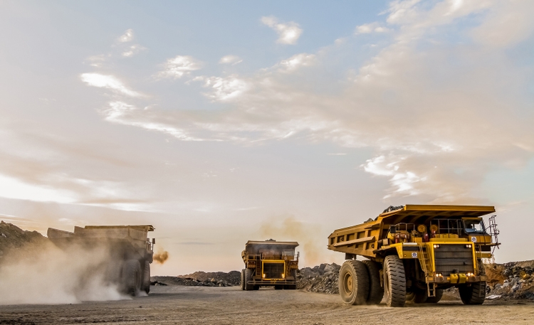 Mining trucks transporting Platinum ore for processing