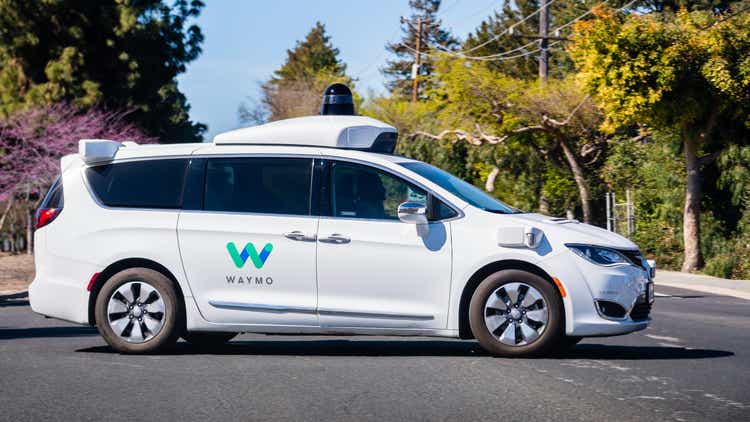 Waymo self driving car performing tests on a street near Google"s offices