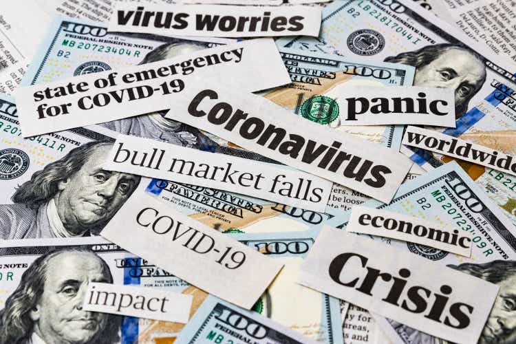 Coronavirus, covid-19 news headlines on United States of America 100 dollar bills. Concept of financial impact, stock market decline and crash due to worldwide pandemic