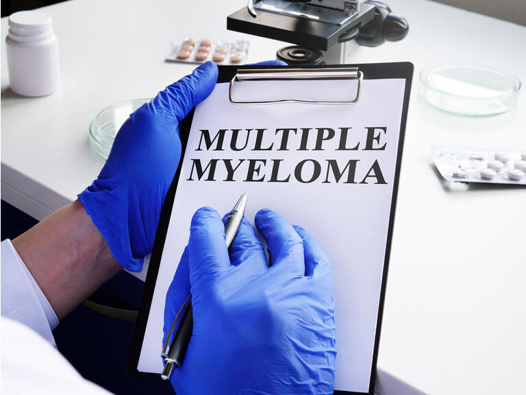 Doctor in blue gloves reads about Multiple myeloma.